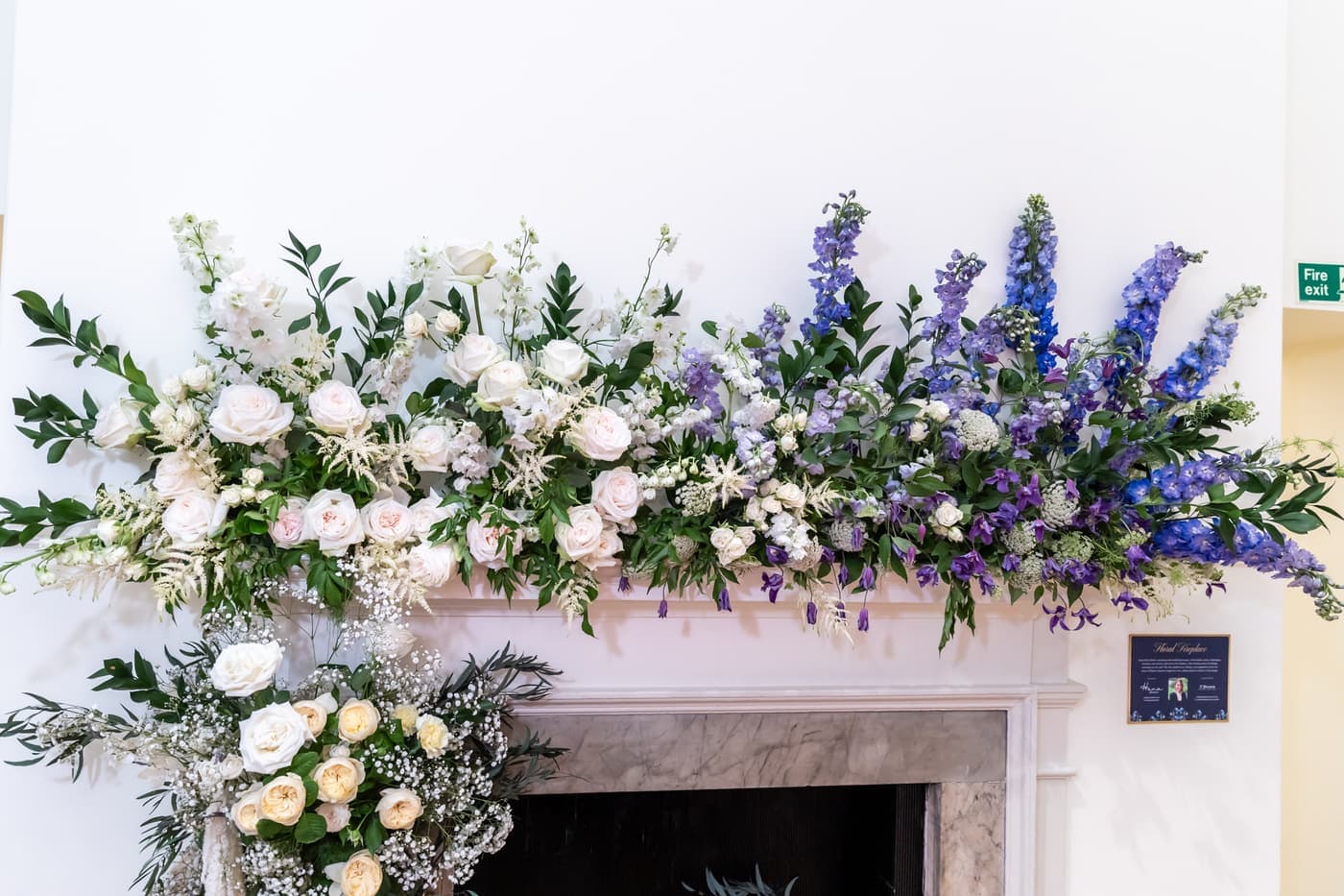 The full DIANA mantel: a long garland of white roses shading into blue delphinium