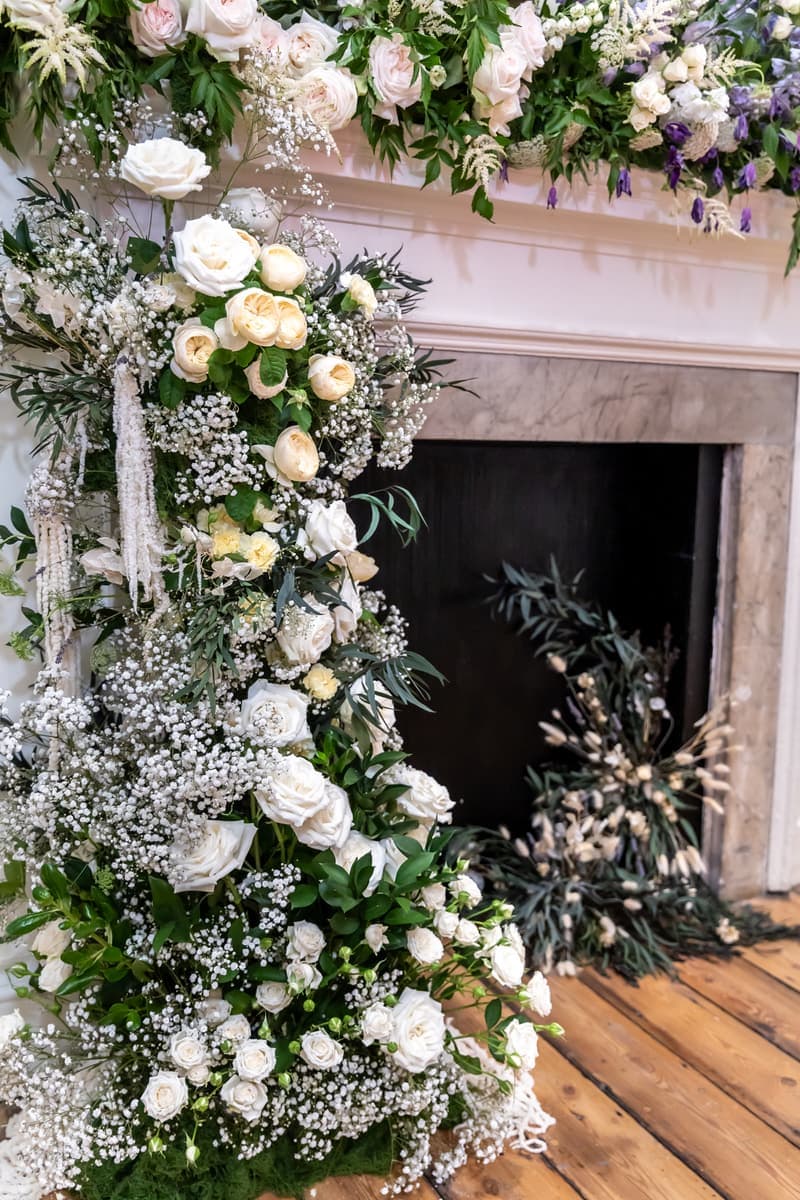 Close view of the flowers cascading down the side of the fireplace to the floorboards